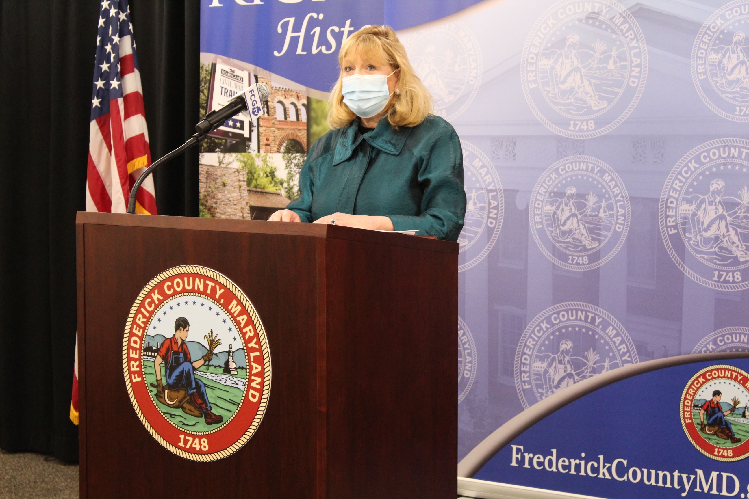 Image shows County Executive Gardner at a lectern, with the Frederick County seal affixed to it.