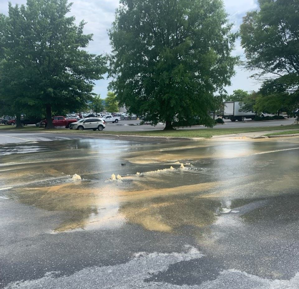 Water bubbles up through pavement along Guilford Drive
