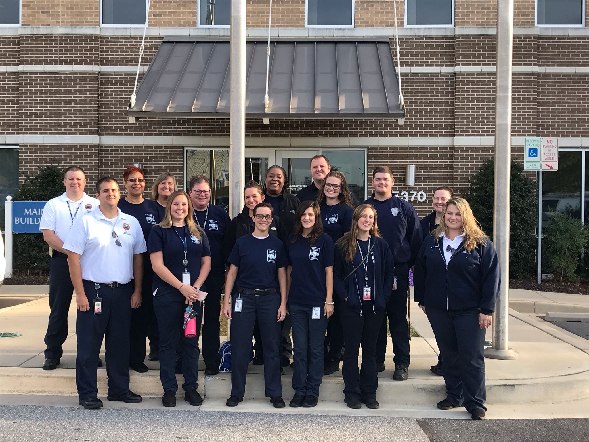 Department of Emergency Communications (9-1-1) staff, smiling and posing for a group photo