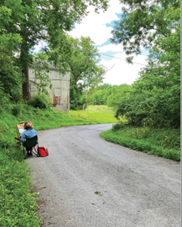Artist draws on the side of the road