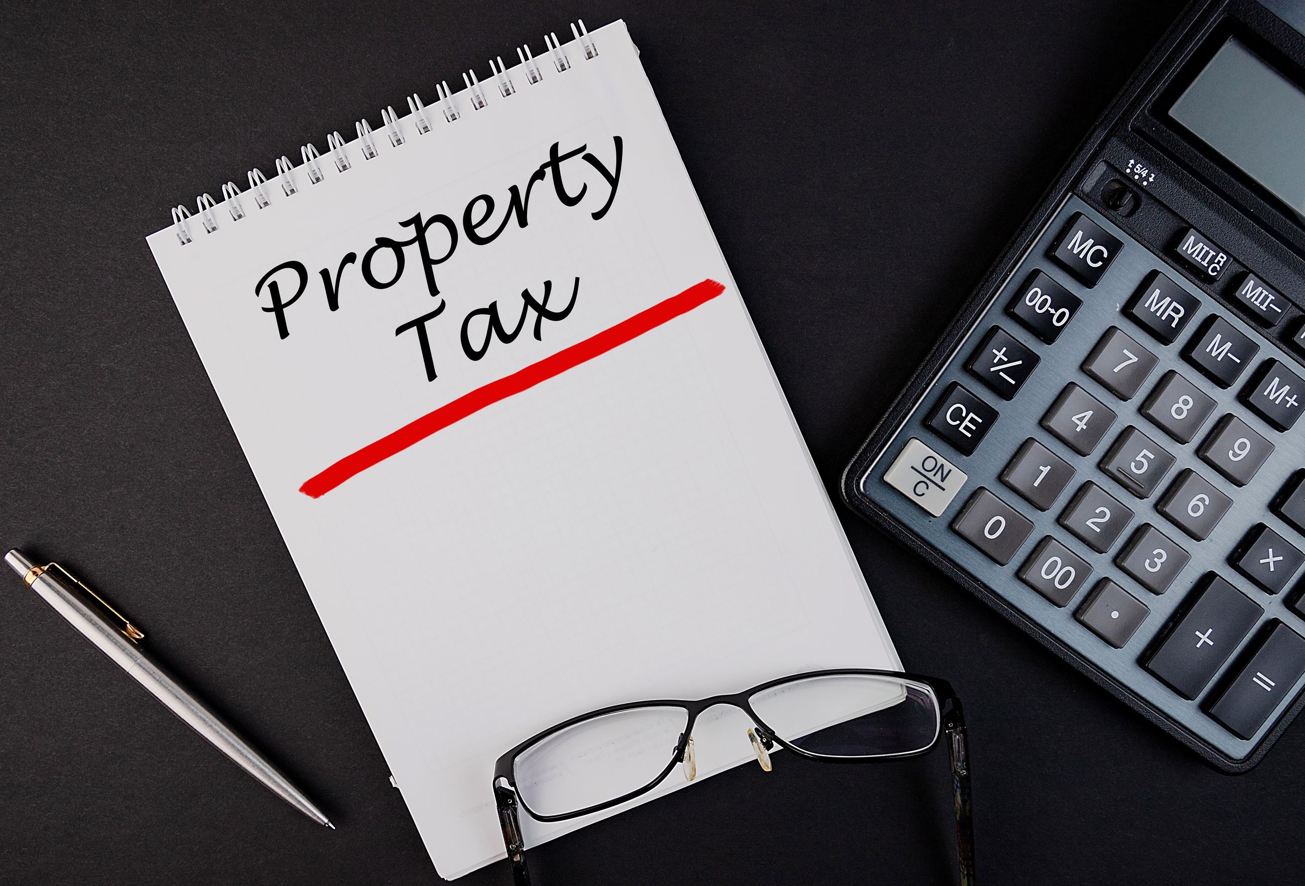 A calculator, pen and notebook