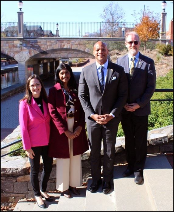 A row of people standing outside on steps 