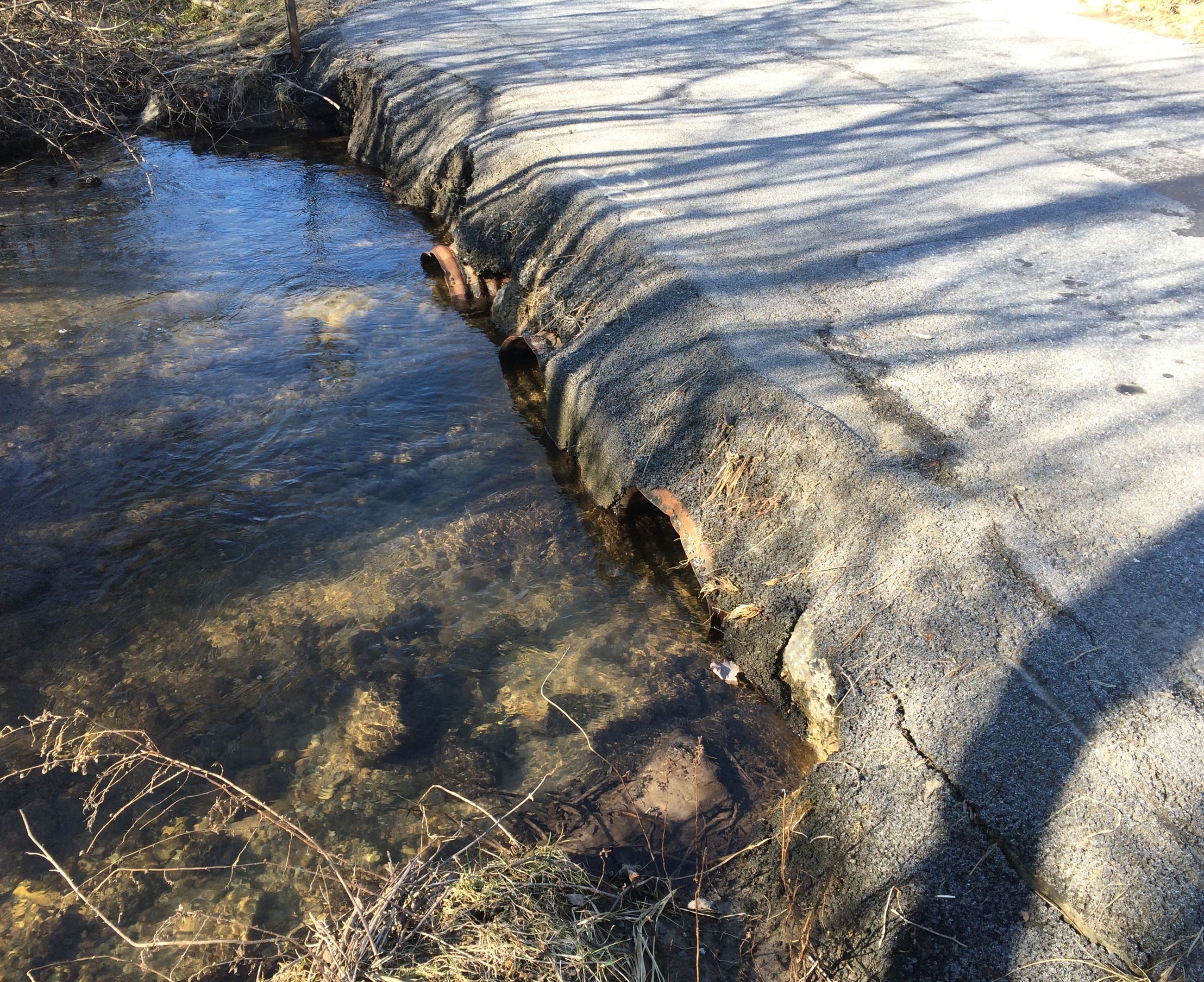 A culvert underneath pavement