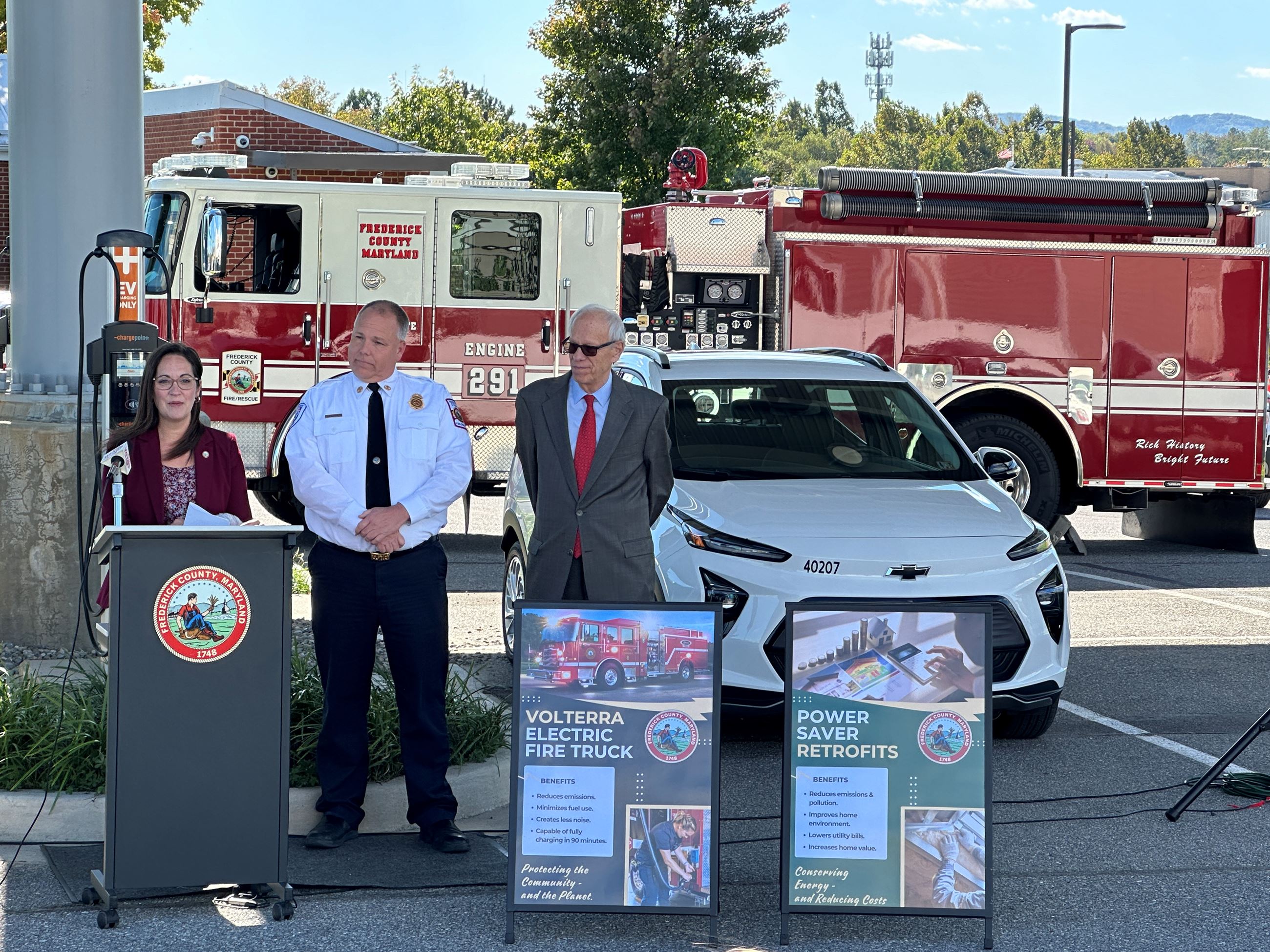 Image of community leaders speaking at a podium