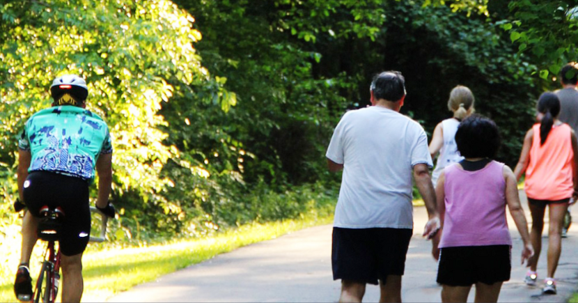 People walk and bicycling along a trail