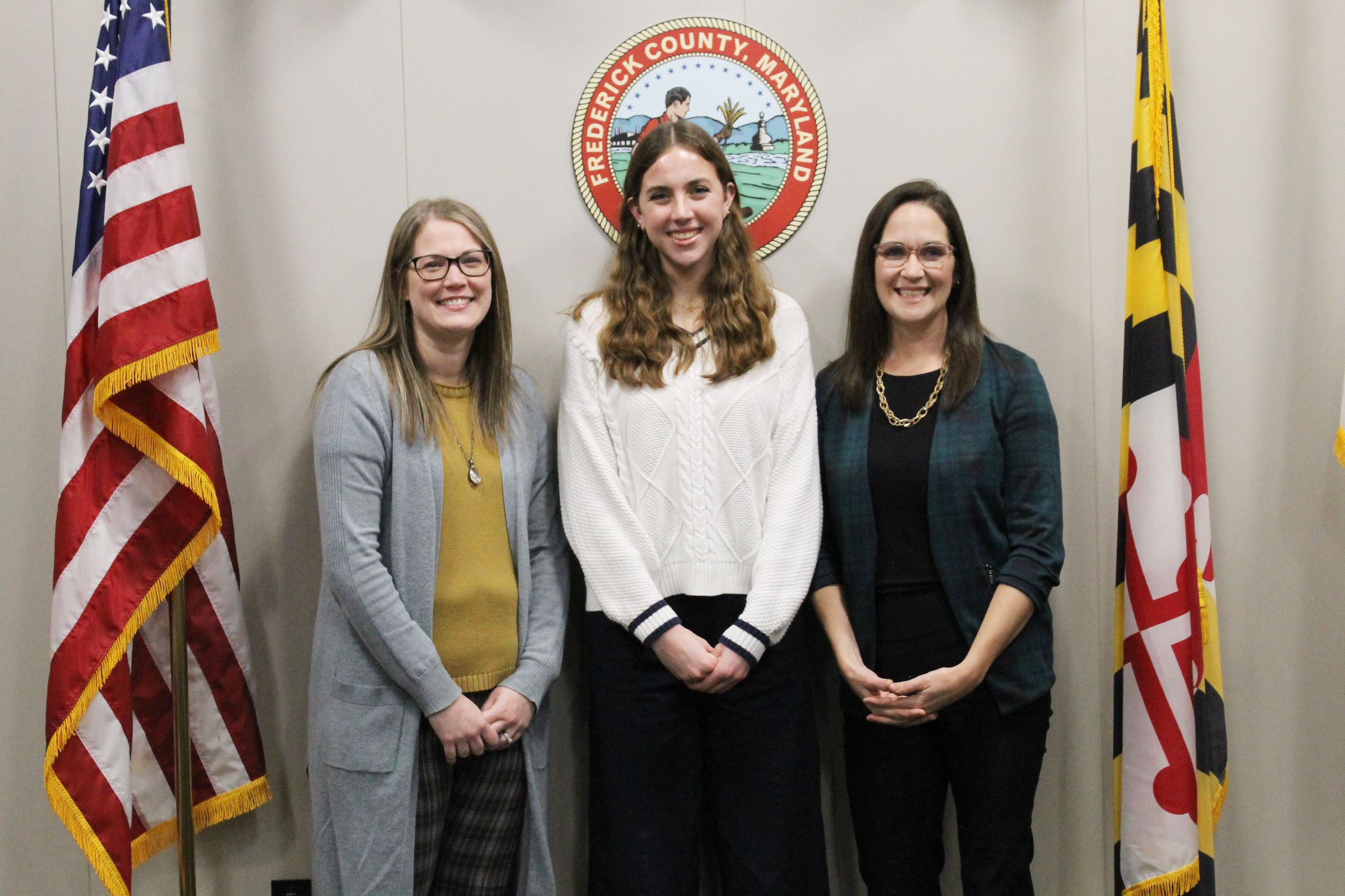 Three women pose for a photo.