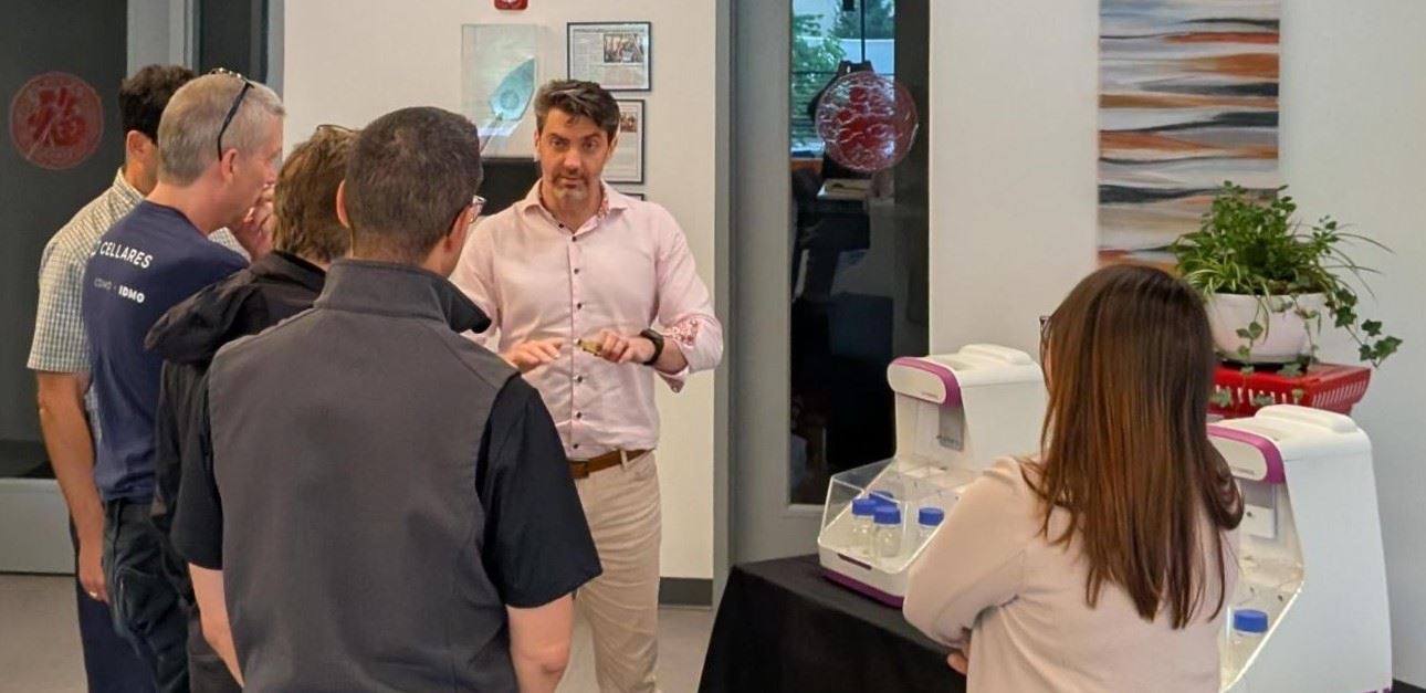 a group of people in a room at a networking and device demonstration event