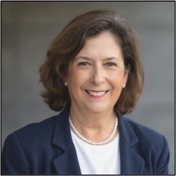 A headshot of a woman smiling.