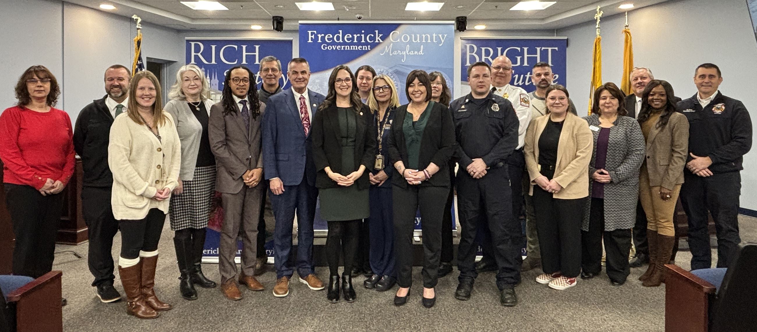 A group of people posing for a photo in a conference room.